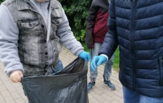 uczniowie sprzątający teren wokół stawu Kajaki